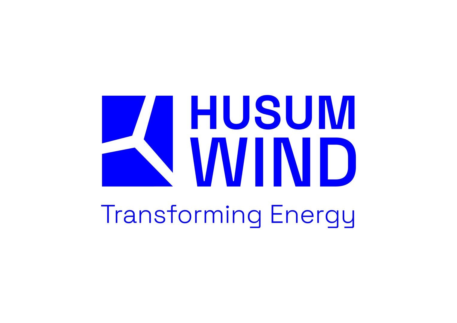 Logo for HUSUM WIND with a blue wind turbine symbol next to the text "HUSUM WIND" in bold blue lettering, below the slogan "Transforming Energy" in a lighter blue.