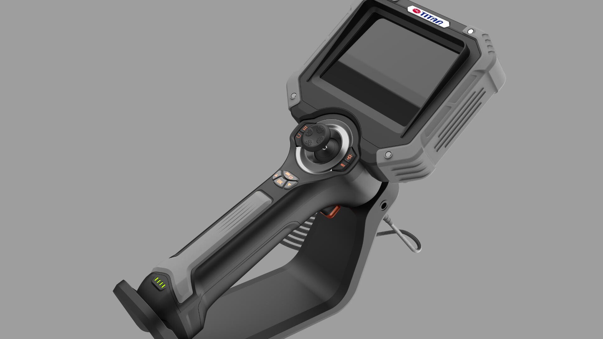 Ein tragbares elektronisches Inspektionsgerät mit großem Farbbildschirm, mehreren Tasten, Joystick und ergonomischem Griff, dargestellt auf grauem Hintergrund. Ein kleines Kabel ragt seitlich heraus.